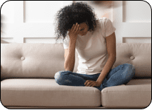 woman fatigued on the couch
