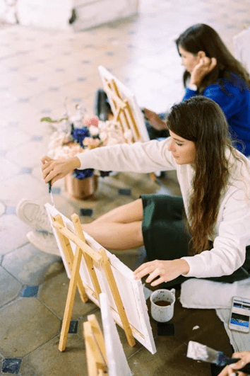 women painting on easels
