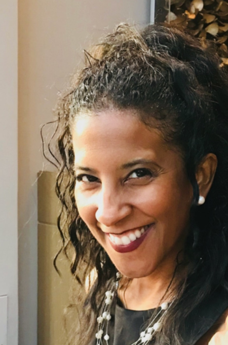 Dawn Morgan, headshot. She is facing forward and smiling against a neutral background.