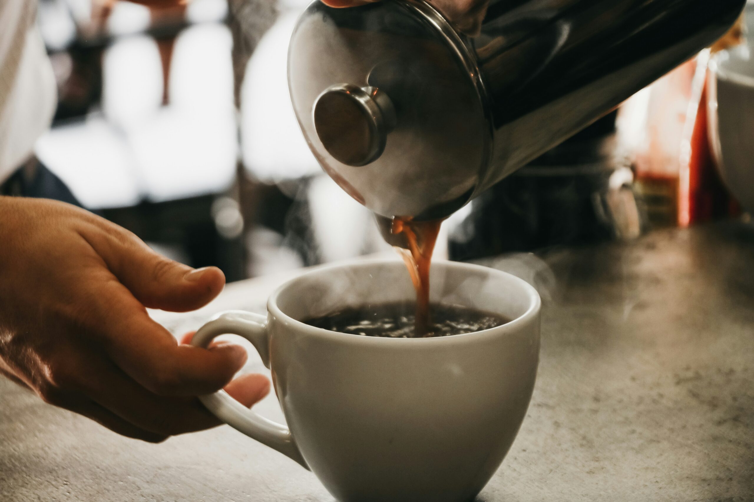 Close up of coffee being poured into a mug