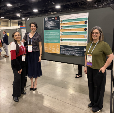 iConquerMS member Nora Gutierrez, Cristina A. F. Román, and ACP Chief Scientific Officer Stephanie Buxhoeveden standing in front of a poster at CMSC
