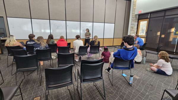 ACP Chief Scientific Officer Stephanie Buxhoeveden stands in front of classroom with campers sitting in the audience, having a discussion